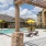 pool with lounge chairs and clubhouse